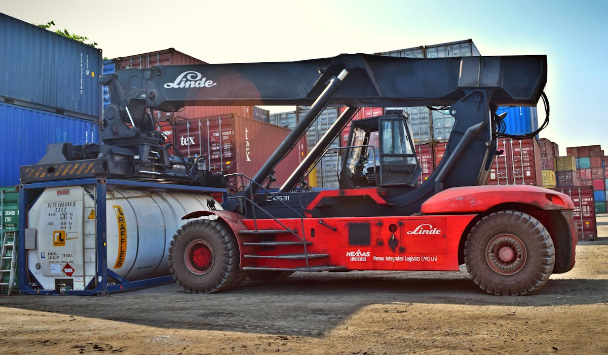 Forklift moving containers in warehouse
